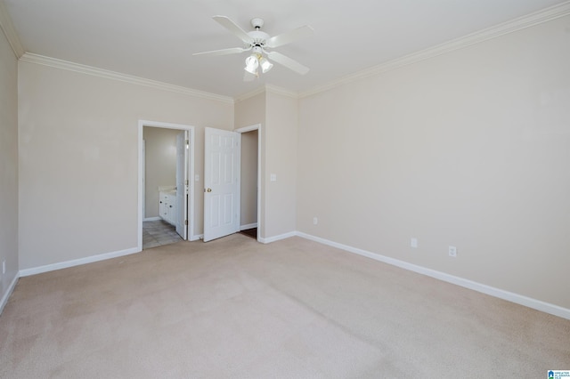 unfurnished bedroom with light carpet, ensuite bathroom, crown molding, and baseboards