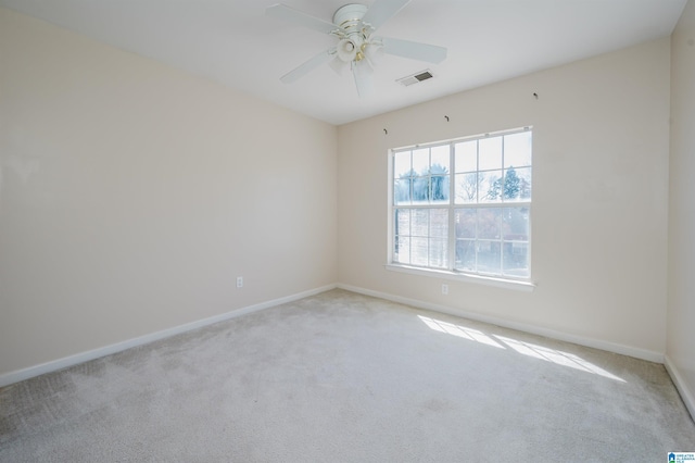 empty room with visible vents, a ceiling fan, baseboards, and carpet floors