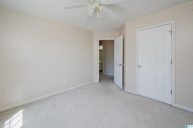 unfurnished bedroom featuring ceiling fan, baseboards, and light carpet