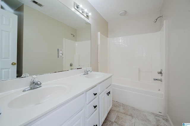 full bathroom featuring double vanity, visible vents, shower / washtub combination, and a sink