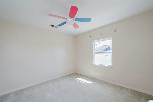 spare room featuring visible vents, baseboards, light colored carpet, and a ceiling fan