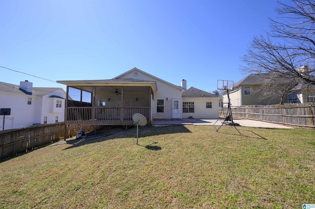 rear view of house featuring a yard, a patio, and a fenced backyard