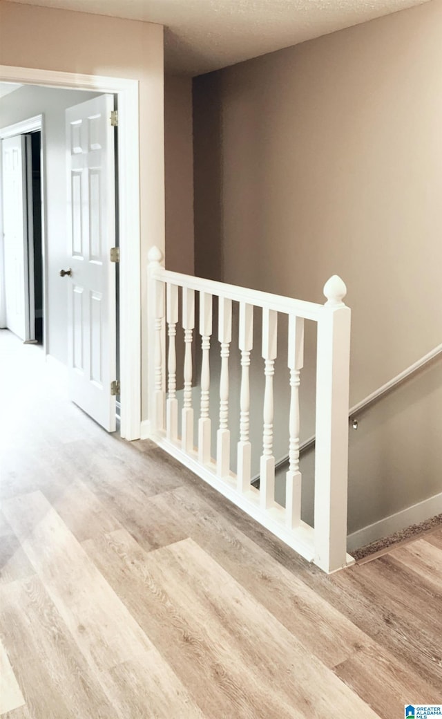 stairs with baseboards and wood finished floors