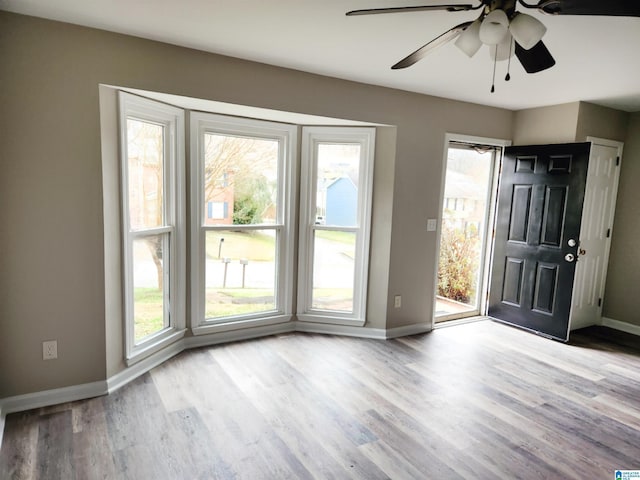 interior space with baseboards and wood finished floors