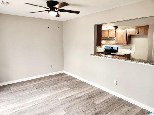 kitchen with tasteful backsplash, visible vents, electric stove, and wood finished floors