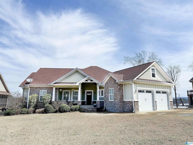 craftsman-style home with stone siding, a garage, board and batten siding, and driveway