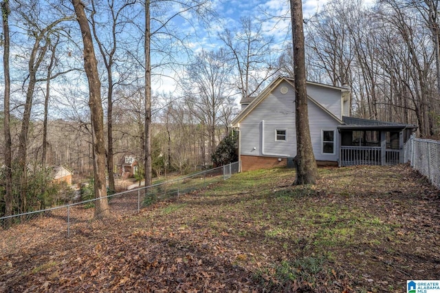 view of side of property featuring a fenced backyard and a chimney