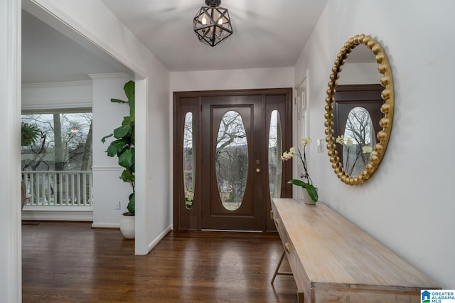 foyer featuring baseboards and dark wood-style flooring