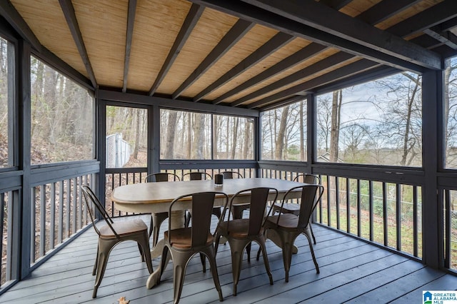 sunroom with a wealth of natural light and beamed ceiling