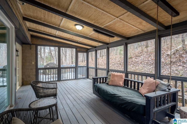 sunroom / solarium featuring a wealth of natural light, wood ceiling, and lofted ceiling with beams