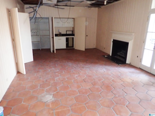 interior space with a fireplace with raised hearth