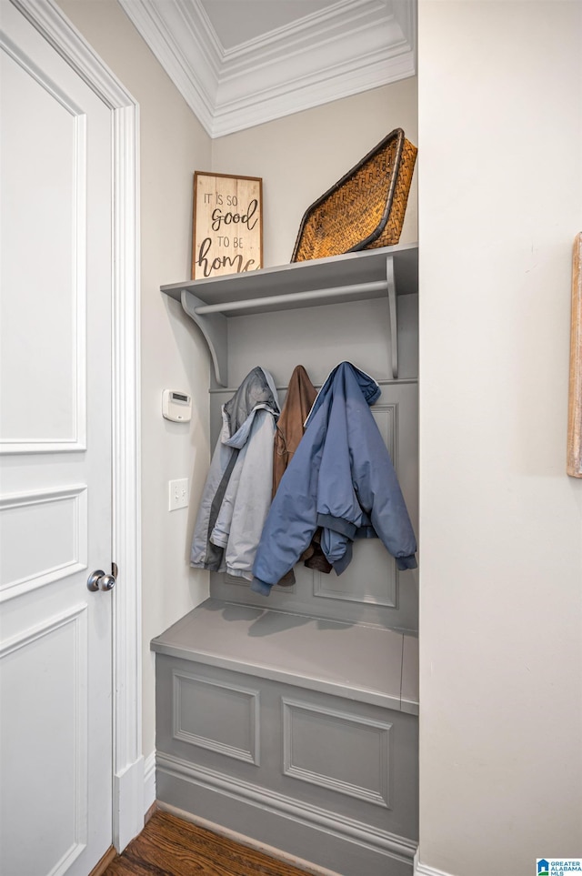 mudroom with crown molding and wood finished floors