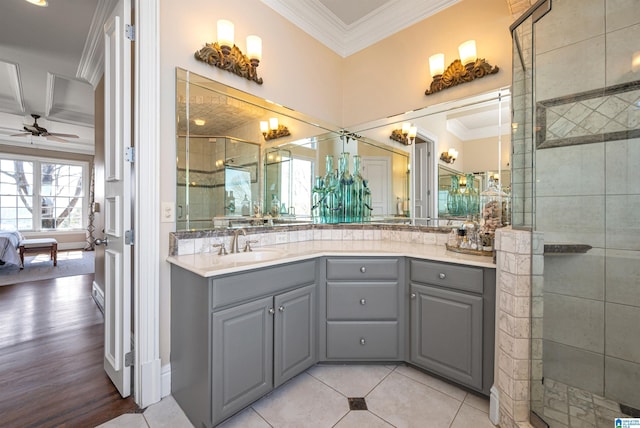 ensuite bathroom with a stall shower, vanity, crown molding, and ceiling fan