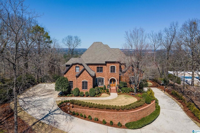 view of front of house featuring brick siding and driveway