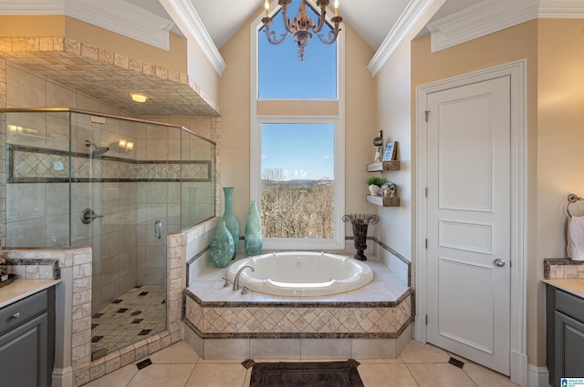 bathroom with crown molding, a garden tub, a stall shower, tile patterned floors, and vanity