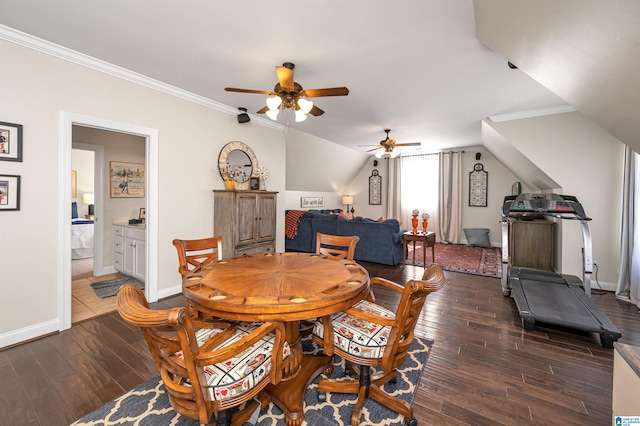 dining area featuring baseboards, dark wood-type flooring, lofted ceiling, and ornamental molding