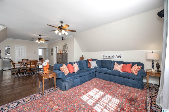 living room with vaulted ceiling, wood finished floors, and ornamental molding