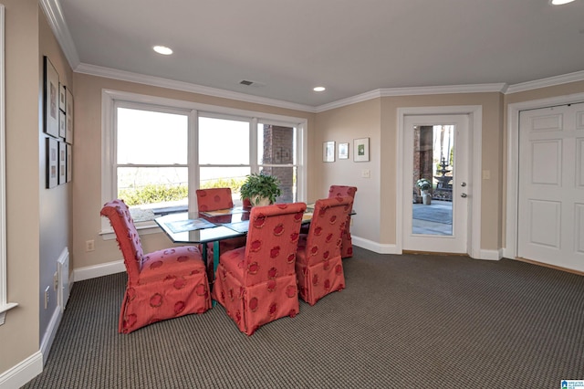 carpeted dining space featuring baseboards, plenty of natural light, visible vents, and ornamental molding