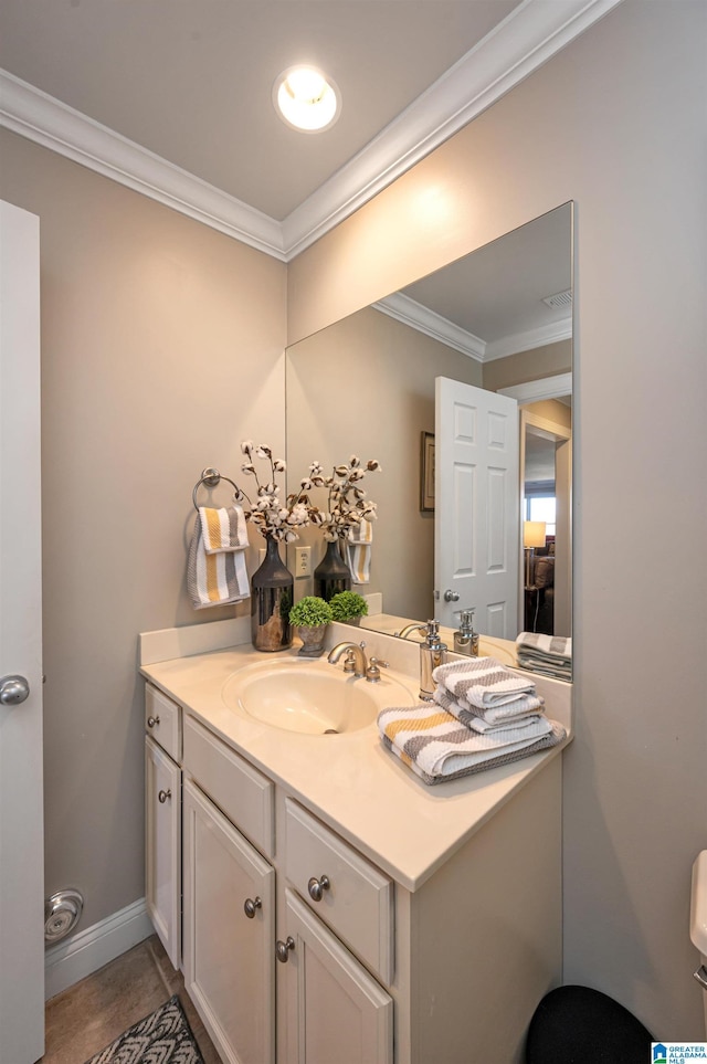 bathroom with vanity, baseboards, and ornamental molding