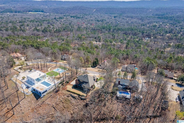 birds eye view of property with a forest view