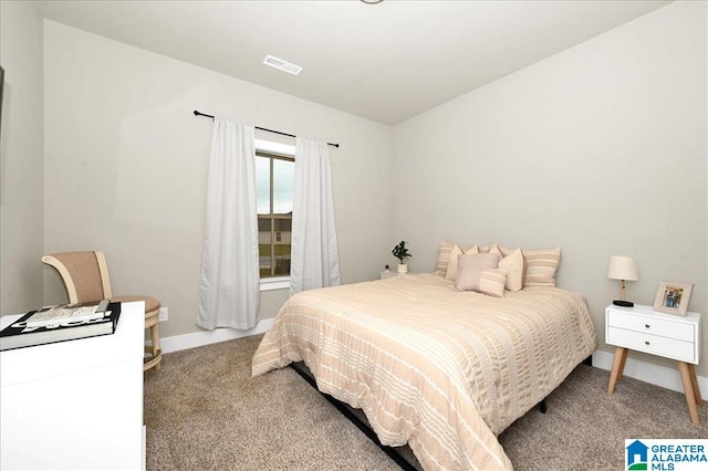 carpeted bedroom featuring visible vents and baseboards