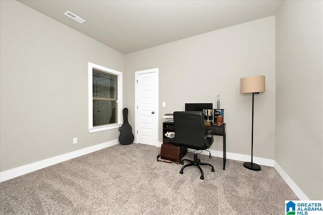 carpeted office space featuring visible vents and baseboards