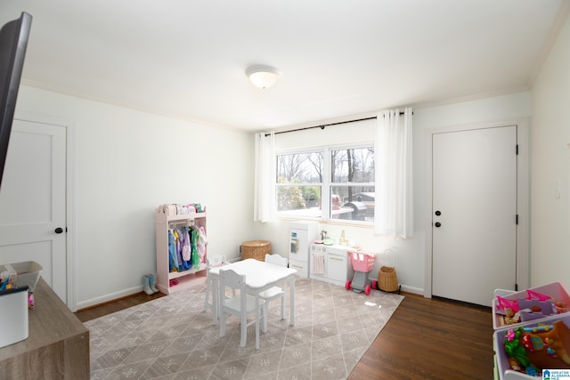 playroom featuring baseboards and wood finished floors