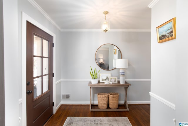 entryway with plenty of natural light, wood finished floors, visible vents, and ornamental molding