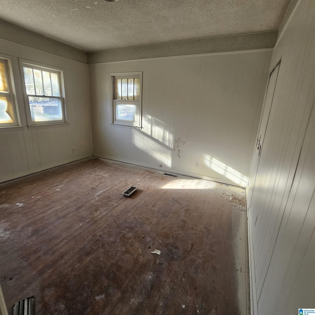 spare room featuring visible vents and a textured ceiling