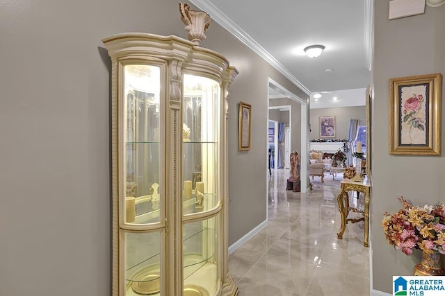 hallway featuring baseboards, marble finish floor, and ornamental molding