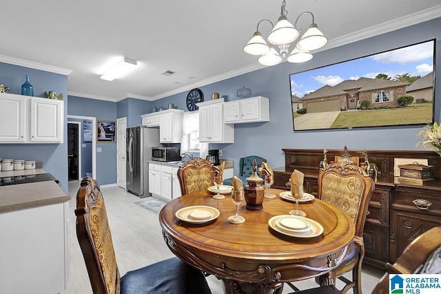 dining space featuring visible vents, crown molding, and light wood finished floors