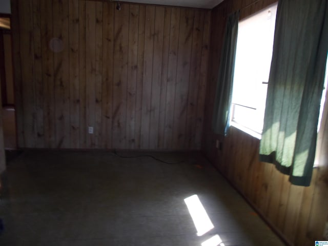 empty room featuring wood walls