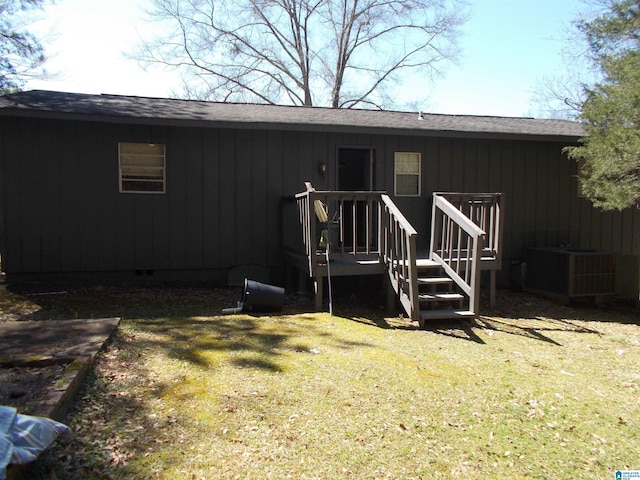 doorway to property with crawl space, a yard, central AC unit, and a shingled roof