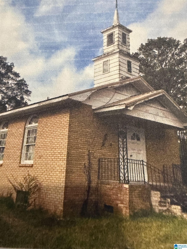 view of side of home with brick siding