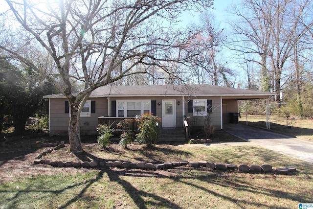 ranch-style house featuring a front yard, an attached carport, and driveway