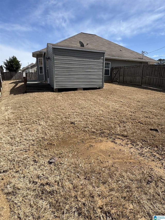 rear view of house featuring fence