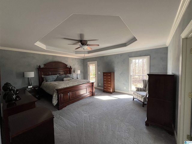 bedroom featuring a ceiling fan, a raised ceiling, carpet flooring, and crown molding