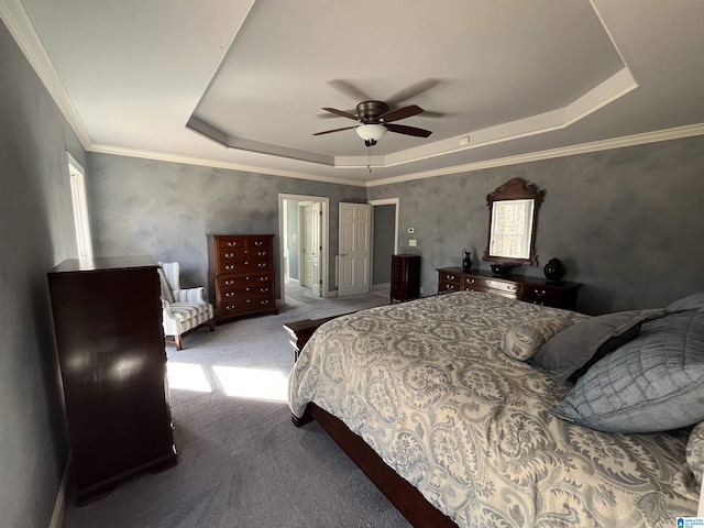 bedroom featuring a tray ceiling, ceiling fan, carpet flooring, and ornamental molding