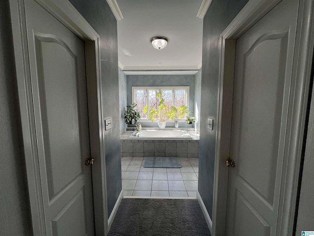 hallway with crown molding and baseboards