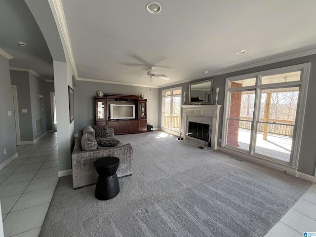 unfurnished living room with a wealth of natural light, visible vents, and a high end fireplace