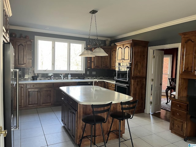 kitchen with a kitchen island, double wall oven, freestanding refrigerator, light countertops, and tasteful backsplash