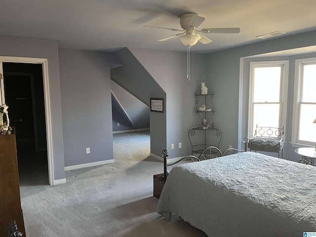 carpeted bedroom featuring visible vents, baseboards, and ceiling fan