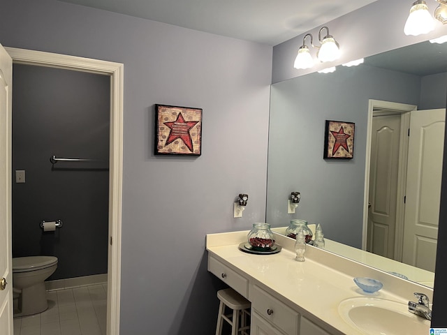 bathroom featuring tile patterned floors, baseboards, toilet, and vanity