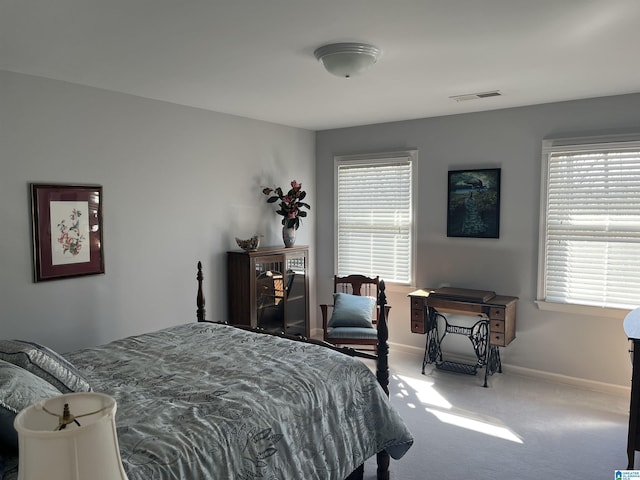 bedroom with visible vents, carpet floors, and baseboards