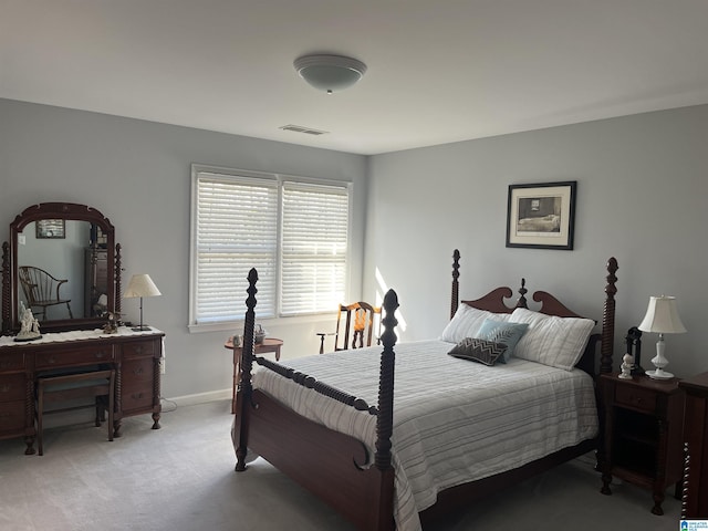 bedroom with visible vents, light colored carpet, and baseboards