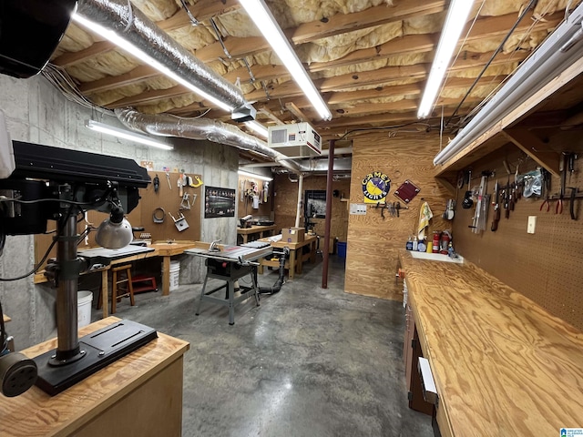 unfinished basement featuring a workshop area