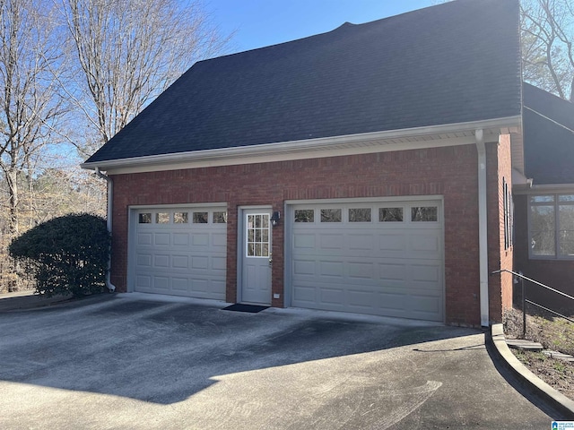 garage featuring concrete driveway