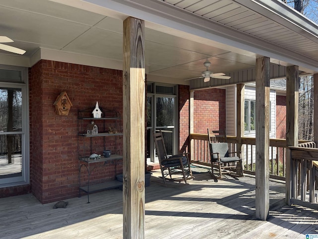 wooden terrace with covered porch and ceiling fan