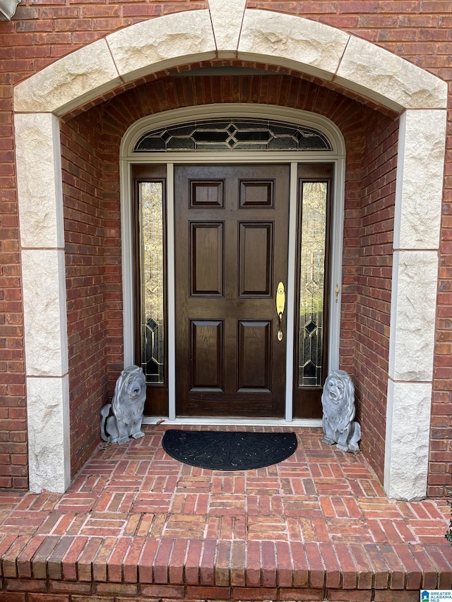 property entrance with brick siding