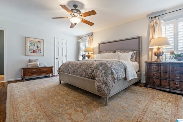 bedroom with a ceiling fan and baseboards